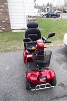 Front angle of red Drive Medical mobility scooter showing basket, seat and body