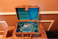 Basket open showing blue interior and wrapped tableware