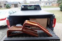 Two steel auto ramps placed on pickup truck tailgate
