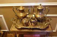 Five-piece silver-plated tea and coffee set on ornate tray