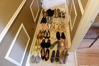 All 26 pairs of women’s size 9 shoes laid out in hallway