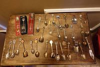 Top view of entire assortment of boxed and loose collectible spoons