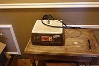 Front and top view of Glastar Super Star stained glass grinder showing grid work surface, power cord and logo