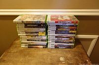 Two stacks totaling thirty Xbox 360 game cases, partial titles visible