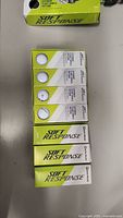 Eighteen TaylorMade Soft Response golf balls in six boxes arranged on a table, showcasing packaging and balls.