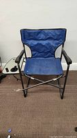 Front view of blue Ozark camping chair with black frame and armrests.