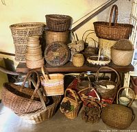 Full assortment of baskets in various sizes, shapes, and styles arranged on shelves and floor.