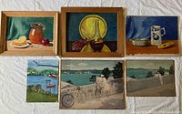 Six oil paintings laid out on a light cloth, three still lifes in the top row, three landscapes in the bottom row. Two still lifes in simple wooden frames, one still life unframed, landscapes unframed on canvas or board.