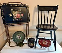Full composition of Hitchcock chair with toleware trays and accessories on display