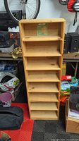 Full front view of solid pine CD shelf unit showing all six shelves and natural wood finish.