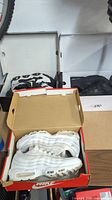 Three pairs of Nike sneakers in original boxes; white Air Max 95, black/white Air More Uptempo, and another pair.