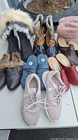 Overview of the lot showing nine women's shoes including boots, clogs, sneakers, and slip-ons, all size 9.