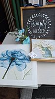 Photo showing the three pictures: 'Simply Blessed' text art, floral painting in gold frame, and large blue flower print.