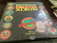 Front cover of black vinyl album labeled Collector Cap Album with Slammer Whammers logos