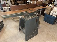 Front and left side view of Toolex 6" jointer showing tables and control knobs, and power cord.