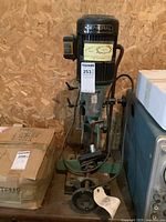 Front view of the entire mortiser showing motor housing, base and vise