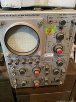 Front view of the oscilloscope showing control panel, CRT display, and labels including the Type 502A and manual note.
