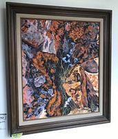 Full front view of framed painting showing abstract rock pattern and blue flowers