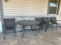 Wide shot of table with four chairs against exterior wall