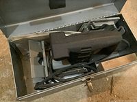 Porter-Cable Model 555 plate jointer inside metal carrying case showing electrical cord and base.