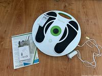 Full view of the Revitive circulation booster with power adapter and instruction guide.