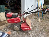 Side profile showing chassis, wheel, tine assembly and handle
