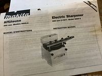 Instruction manual cover showing Makita Electric Sharpener Model 9820-2