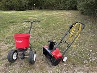 Overview of both Toro snow thrower and Earthway seeder side by side