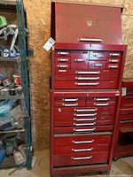 Front view of assembled two-piece red metal tool chest showing top and bottom sections and multiple drawers