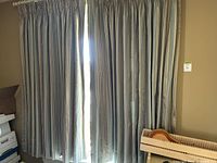 Curtains fully hung over window showing overall size and look in room.