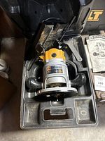 Black & Decker 1-1/2 HP Deluxe Router installed in molded plastic carrying case with visible ergonomic handles and base plate.