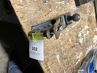 Photo of Stanley metal hand planer on wooden workbench showing front and side angle with wooden knob handle