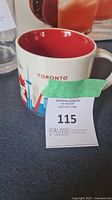 Starbucks Toronto You Are Here ceramic mug with red interior, Toronto graphics including CN Tower and maple leaf.