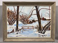 Frontal view of framed winter landscape painting with snow, trees, wooden bridge, barns, and church steeple.