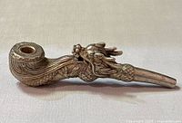 Side view of silver plated dragon pipe showing dragon head and side body details