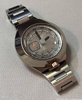 Angled view of the Alba AKA men's wristwatch showing the brushed and polished stainless steel case and bracelet along with the distinct dial and hands.