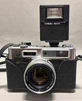 Front view of Yashica Electro 35 G camera with attached Focal M200 flash