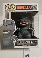 Front view of Funko Pop Godzilla vinyl figure in box showing character, Pop! Movies logo, and number 239.