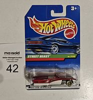 Front view of new Hot Wheels Treasure Hunt Street Beast die-cast car in original packaging showing model No. 7112