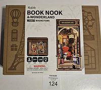 Front view of the Rolife Book Nook & Wonderland Shakespeare Bookstore miniature kit box, showing brand, kit name, age recommendation, and piece count.