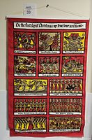 Full view of the linen wall hanging showing all twelve illustrated panels of the song, bordered in red with top and bottom wooden rods and hanging string.