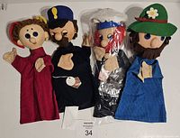 Four vintage hand puppets made in Czechoslovakia placed side by side showing full body and faces.