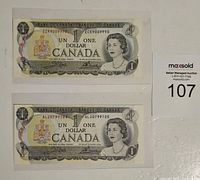 Two Canadian one dollar bills, front side, showing Queen Elizabeth II portrait, serial numbers, and Canadian coat of arms.