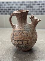 Front profile showing ovoid body, flared neck, handle and spout