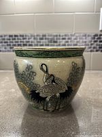 Front view of vintage Japanese Imari-style porcelain fish bowl planter pot showing crane bird design with black feathers, red accents, and green foliage with gold branches.