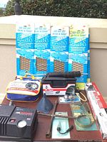 Wide view of auto supplies including Pro-Line Armor Tread Runways, auto cargo bars, tools, funnel, and packaged foot pump