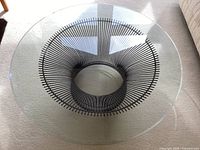 Top-down view of the round glass top and metal wire base