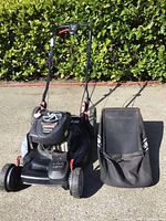 Full front view of mower with grass bag attached