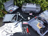 Overview of all tools, cases, manuals and carving supplies arranged on surface