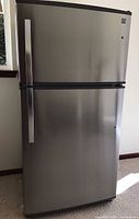 Front view of refrigerator showing stainless steel finish and dual-door layout